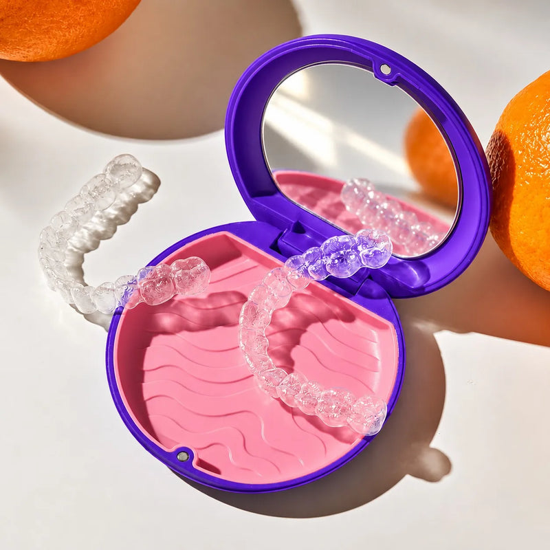 Clear aligners held in a heart shape