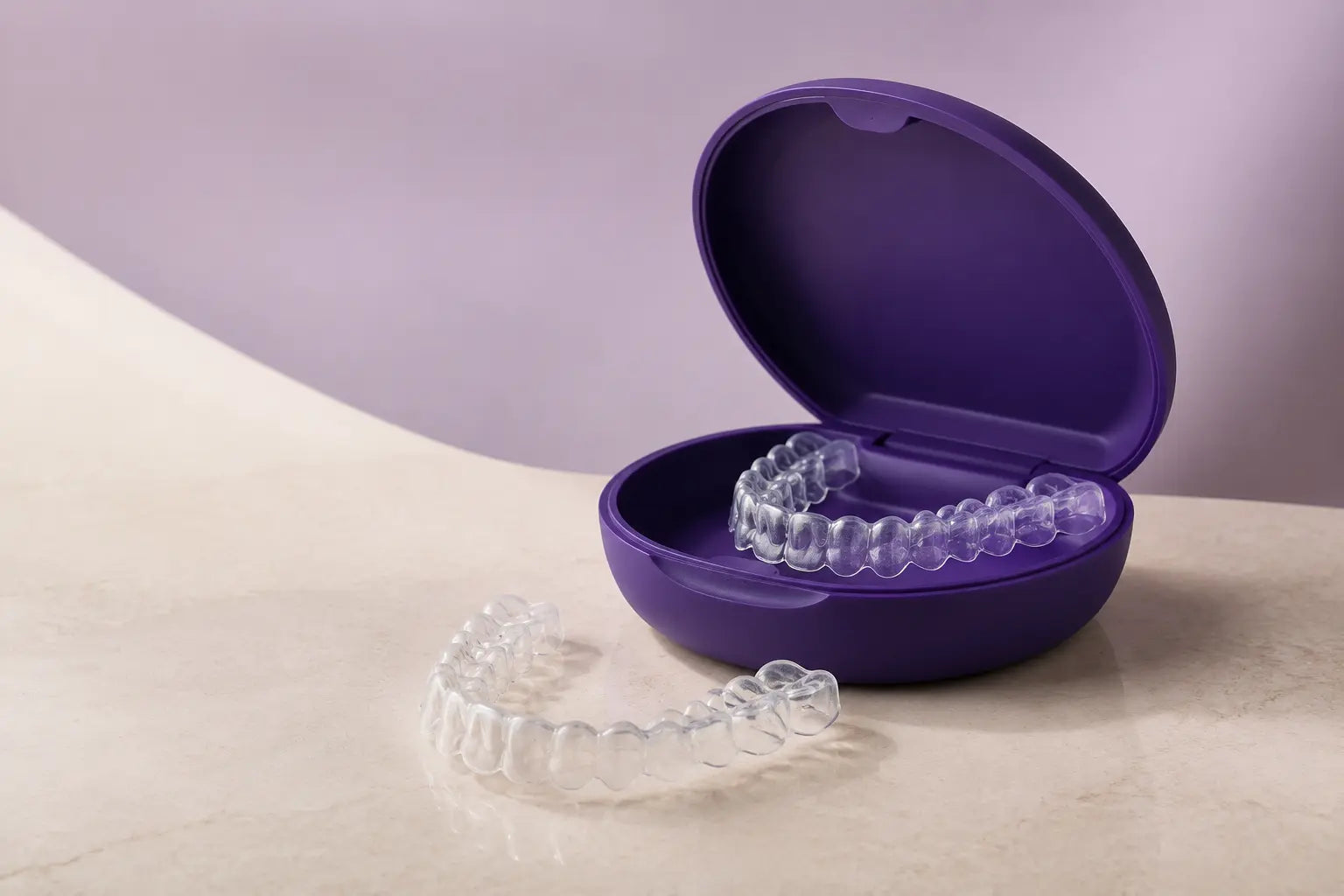 Patient holding custom clear aligners at home
